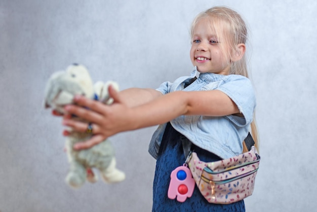 Child playing with a plush toy dog