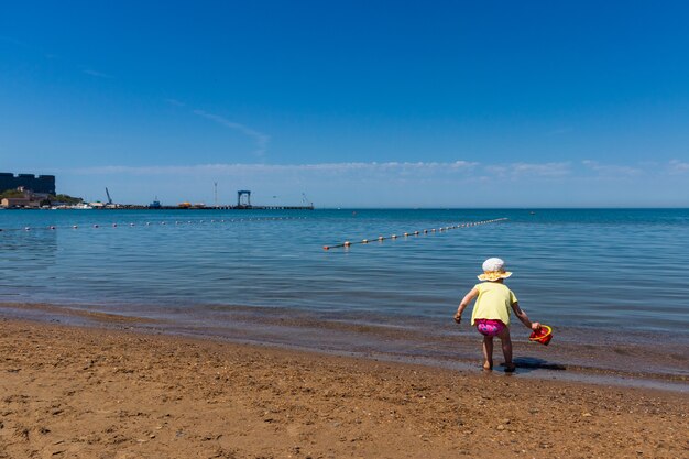  a child plays on the Black Sea coast