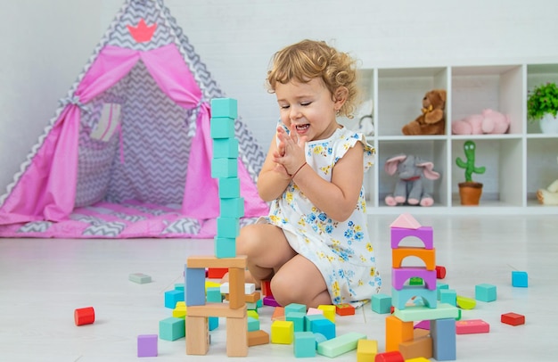 The child plays in the children's room with a wooden constructor Selective focus