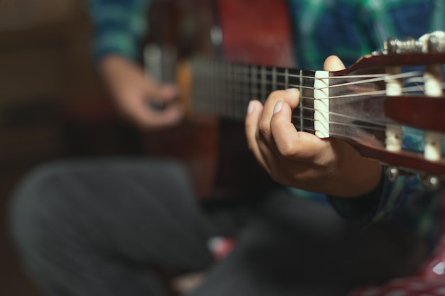 A child plays the classical guitar. detail on the fingers of the left mono that creates a chord