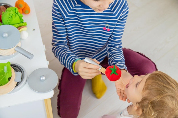 The child plays in the kitchen and cooks Selective focus