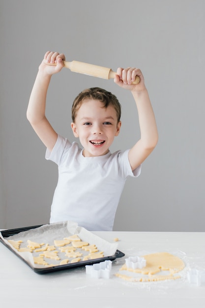 The child prepares homemade Christmas cookies