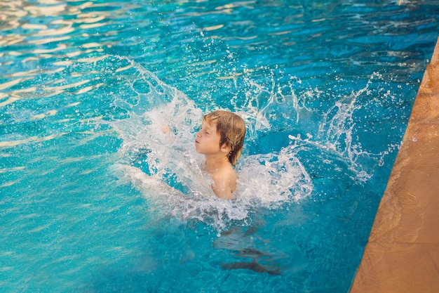 Child run jumps into outdoor pool Happy childs for lifestyle design