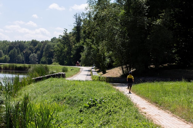 Child runs in the park along the road