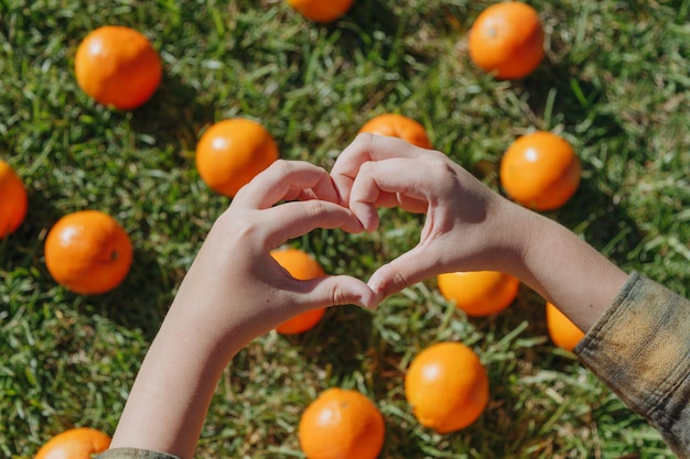 A child's hands are forming a heart with the letters i love you in the middle