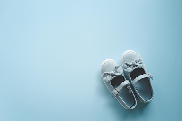 Child's shoes on color background top view flat lay