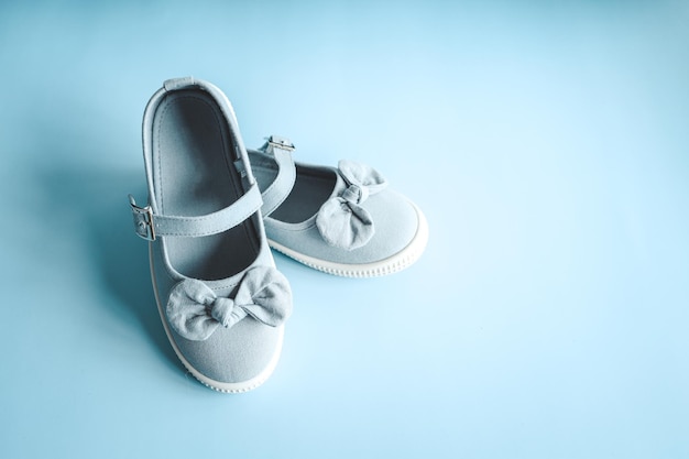 Photo child's shoes on color background top view flat lay