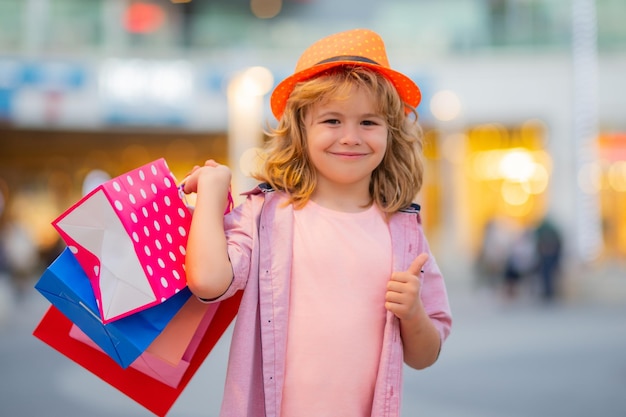 Child on shopping portrait of a kid with shopping bags shopping boy