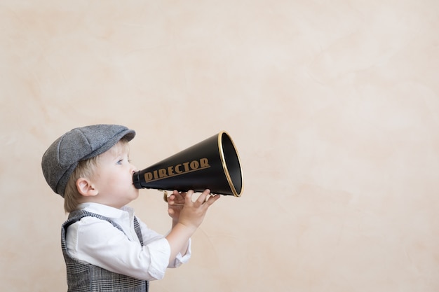 Child shouting through vintage megaphone