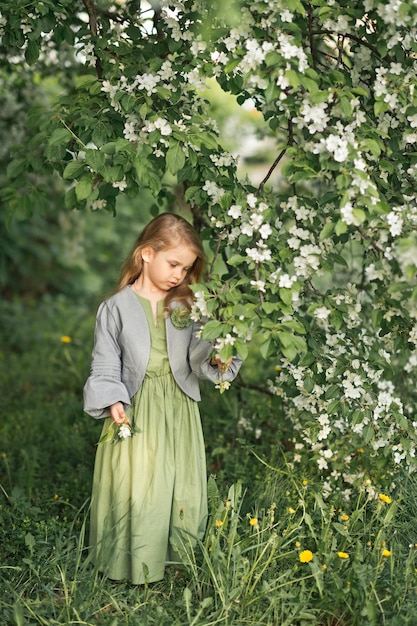 The child stands near a flowering cherry Bush 1803