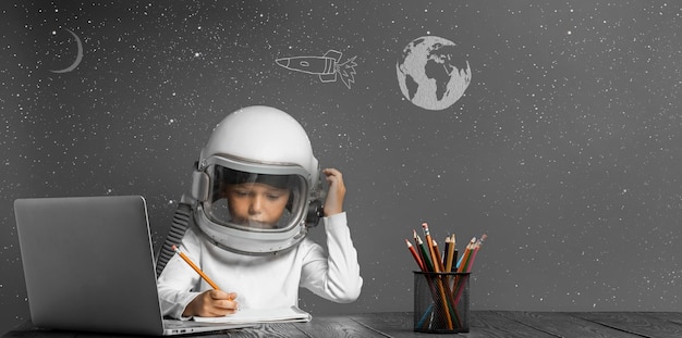 The child studies remotely at school wearing an astronaut's helmet back to school