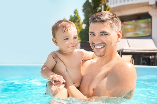 Child swimming lesson Cute little boy with father in pool