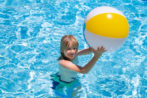 Child swimming in pool play with floating ring smiling cute kid in sunglasses swim with inflatable r