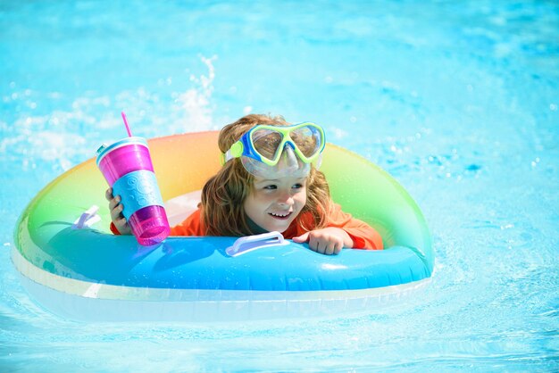 Child in swimming pool playing in water vacation and traveling with kids children play outdoors in s