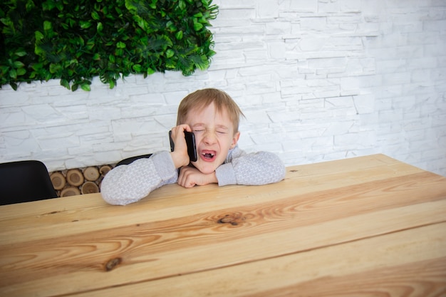 Child talking on the phone Funny boy with the phone