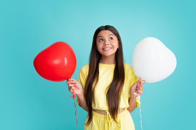 Child teenager girl with red balloons on birthday holiday party Happy girl face positive and smiling emotions