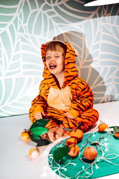 Child in tiger costume eating tangerines