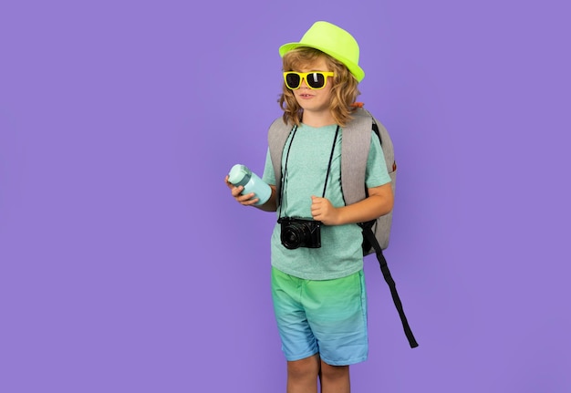 Child tourist with travel bag travelling Kid with suitcase on studio isolated background