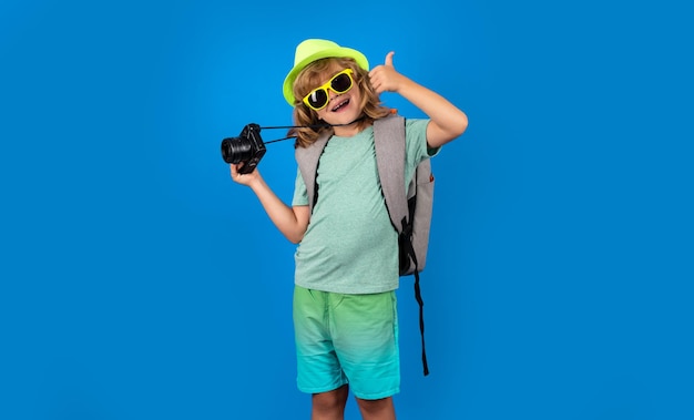 Child tourist with travel bag travelling Kid with suitcase on studio isolated background