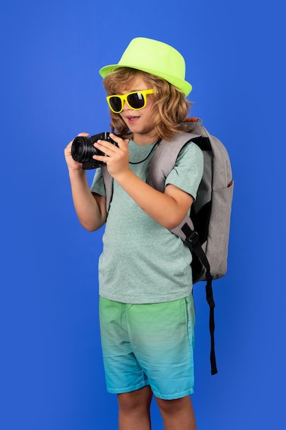 Child traveller photographer with camera taking pictures in studio Kid photo camera Lifestyle travel concept