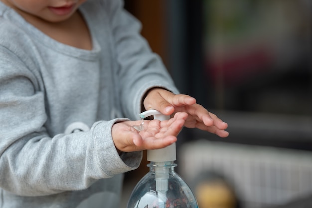 Child Using Hand Sanitizer.