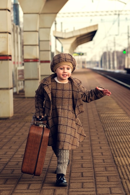 Child waiting for a train at station