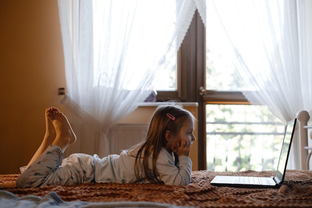 Child watching cartoons on the bed