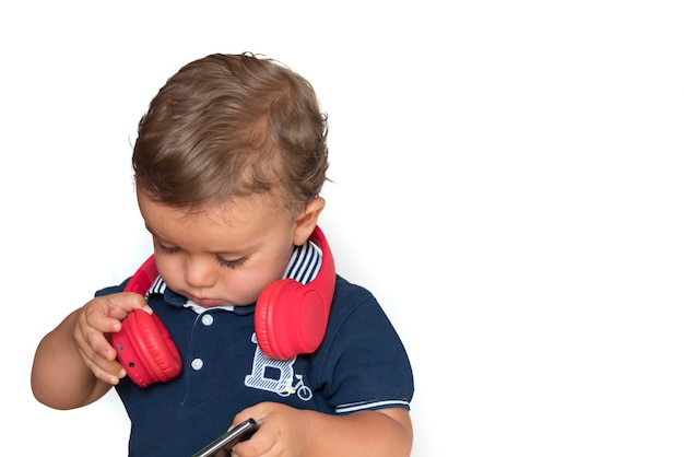 Child watching videos on mobile phone with red headphones and dark blue shirt