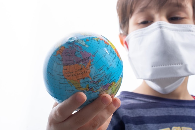 Child wearing face mask holding globe corona virus flu outbreak