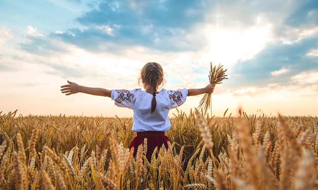 Child in a wheat field In vyshyvanka the concept of the Independence Day of Ukraine Selective focus