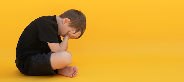 Child whose depression is sitting on the color floor