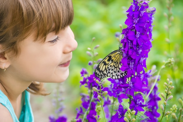 Child with a butterfly. Idea leuconoe. Selective focus.