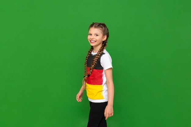 A child with a German flag on a Tshirt Educational German language courses for schoolchildren Green isolated background