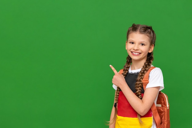 A child with a German flag on a Tshirt points his finger to the side at the advertisement