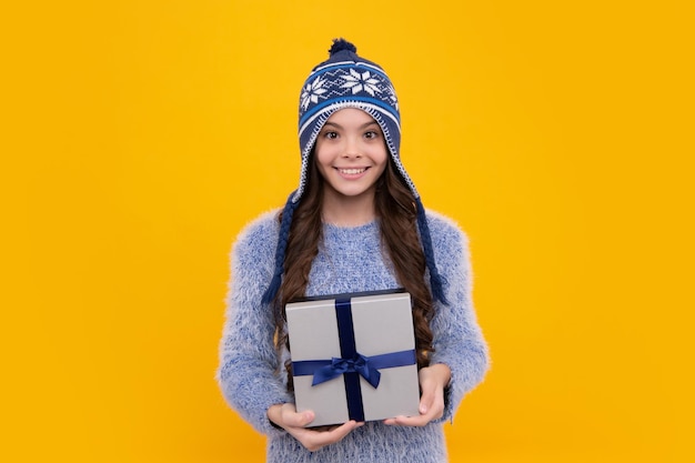 Child with gift present box on isolated background Presents for birthday Valentines day New Year or Christmas Happy face positive and smiling emotions of teenager girl