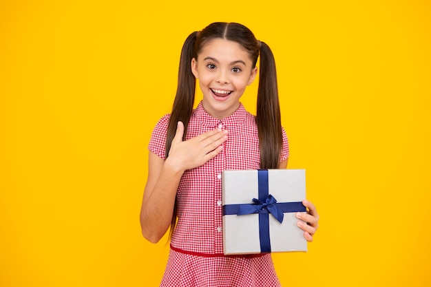 Child with gift present box on isolated background Presents for birthday Valentines day New Year or Christmas Happy teenager positive and smiling emotions of teen girl