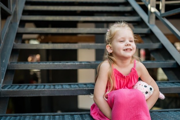 Child with hearing problem and cochlear implant dance in street deaf kid began to hear hearing loss