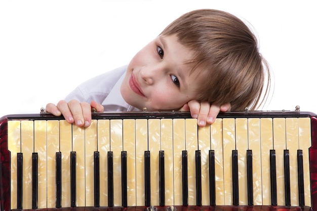 Child with a musical instrument Elementary age boy with an accordion