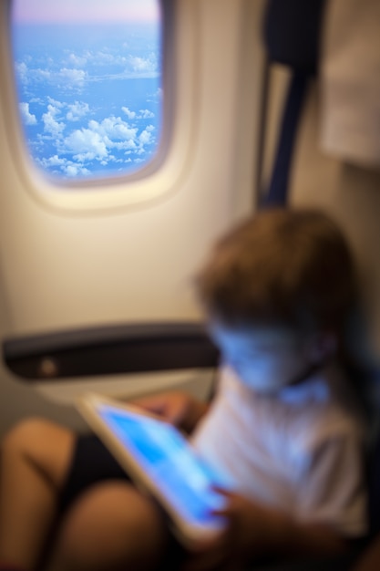 Child with pad in flying plane