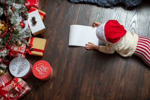 a child writes a letter to Santa Claus