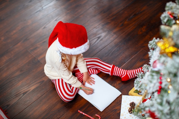 a child writes a letter to Santa Claus