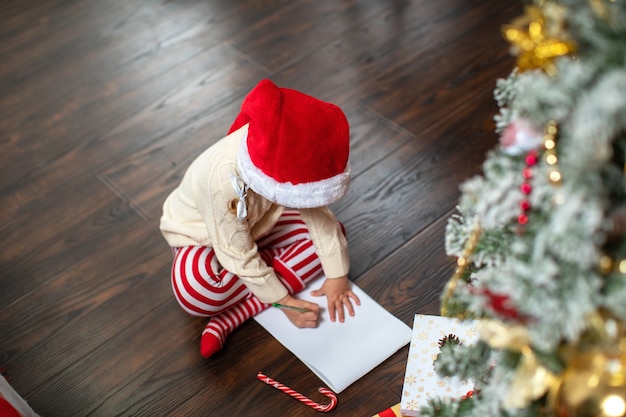 a child writes a letter to Santa Claus