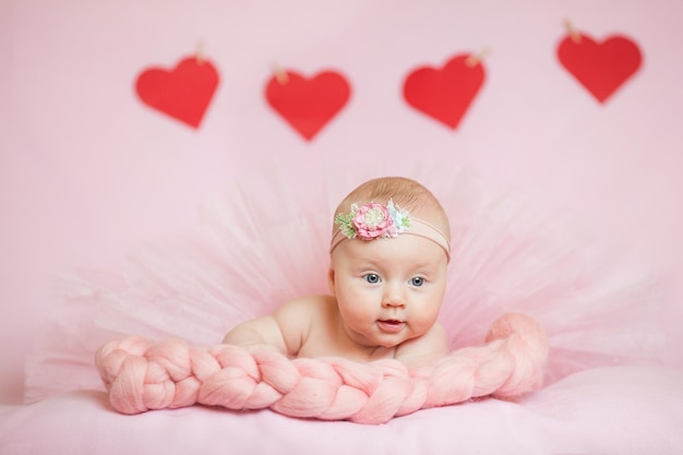 Childhood care motherhood health medicine pediatrics concepts Close up Little peace calm naked infant newborn baby girl in pink hat sleeps resting take deep nap laying on tummy on soft bed