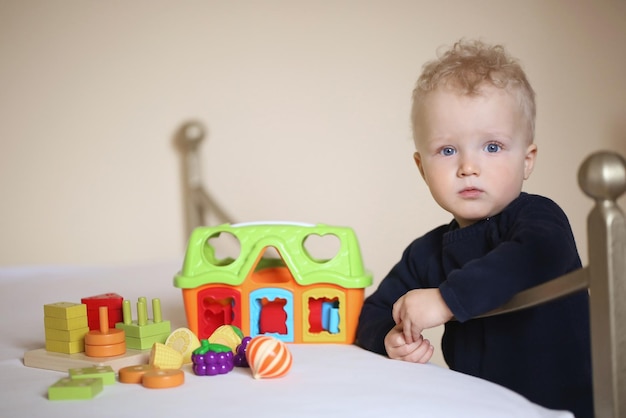 Childhood fun and people concept happy little boy behind door at home