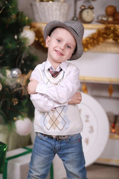 Childhood memories. little boy in hat celebrate christmas at home. Boy child play near christmas tree. Merry and bright christmas. Childhood activity and game. Family holiday.