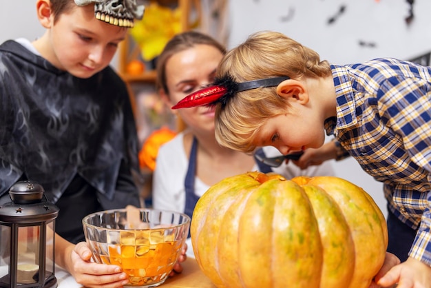 Photo children and adult preparing halloween pumpkin