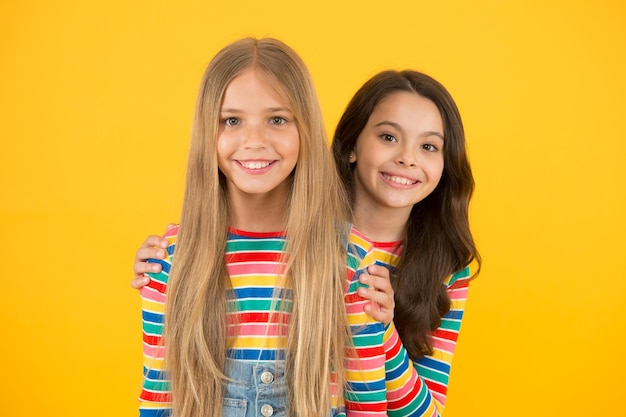 Children are the future Happy children with long hair yellow background Small children in casual style Little children cute smiling International childrens day