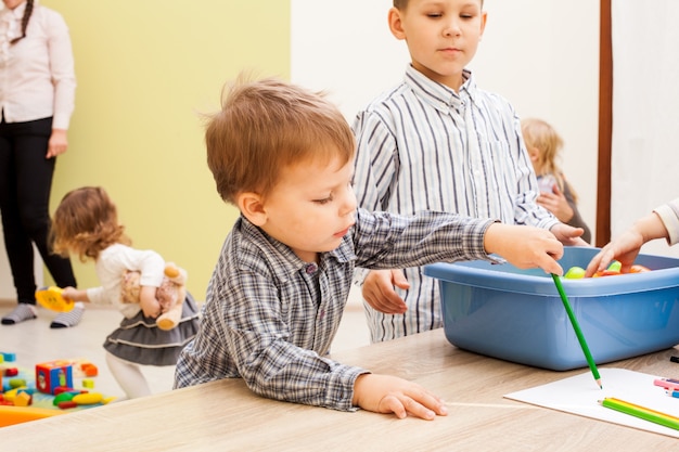 Children are playing with various toys in kindergarten