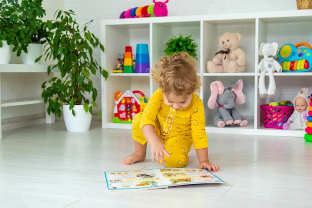 Children are reading a book in the room Selective focus