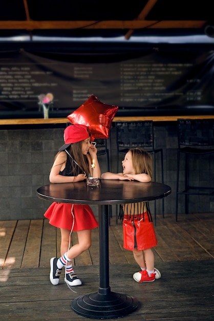 Children celebrate birthday in dark black restaurant tavern